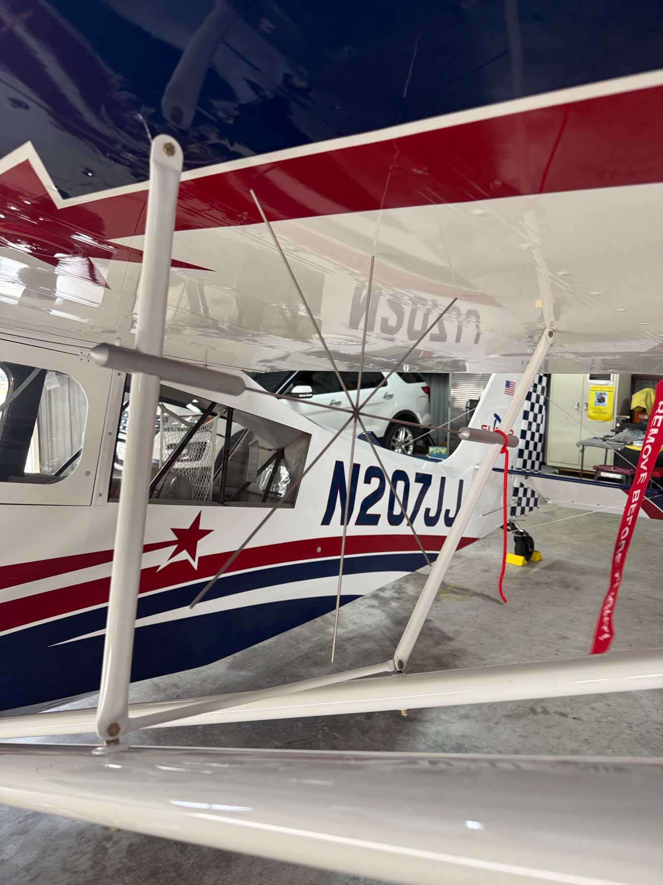 Super Decathlon N207JJ — wing over the clouds