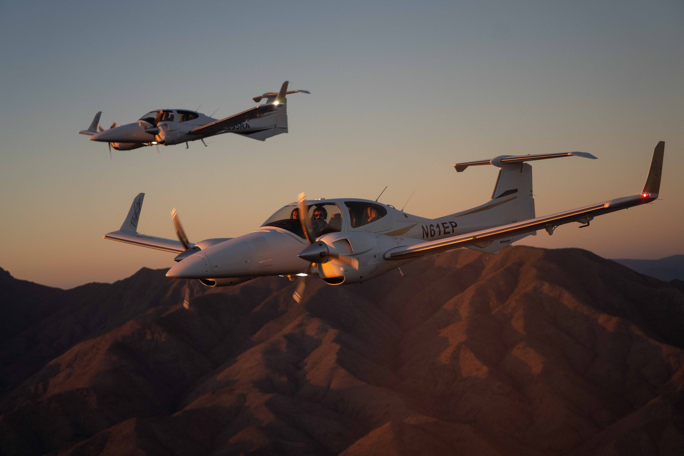 Two Flight Stars DA42s in formation at sunset