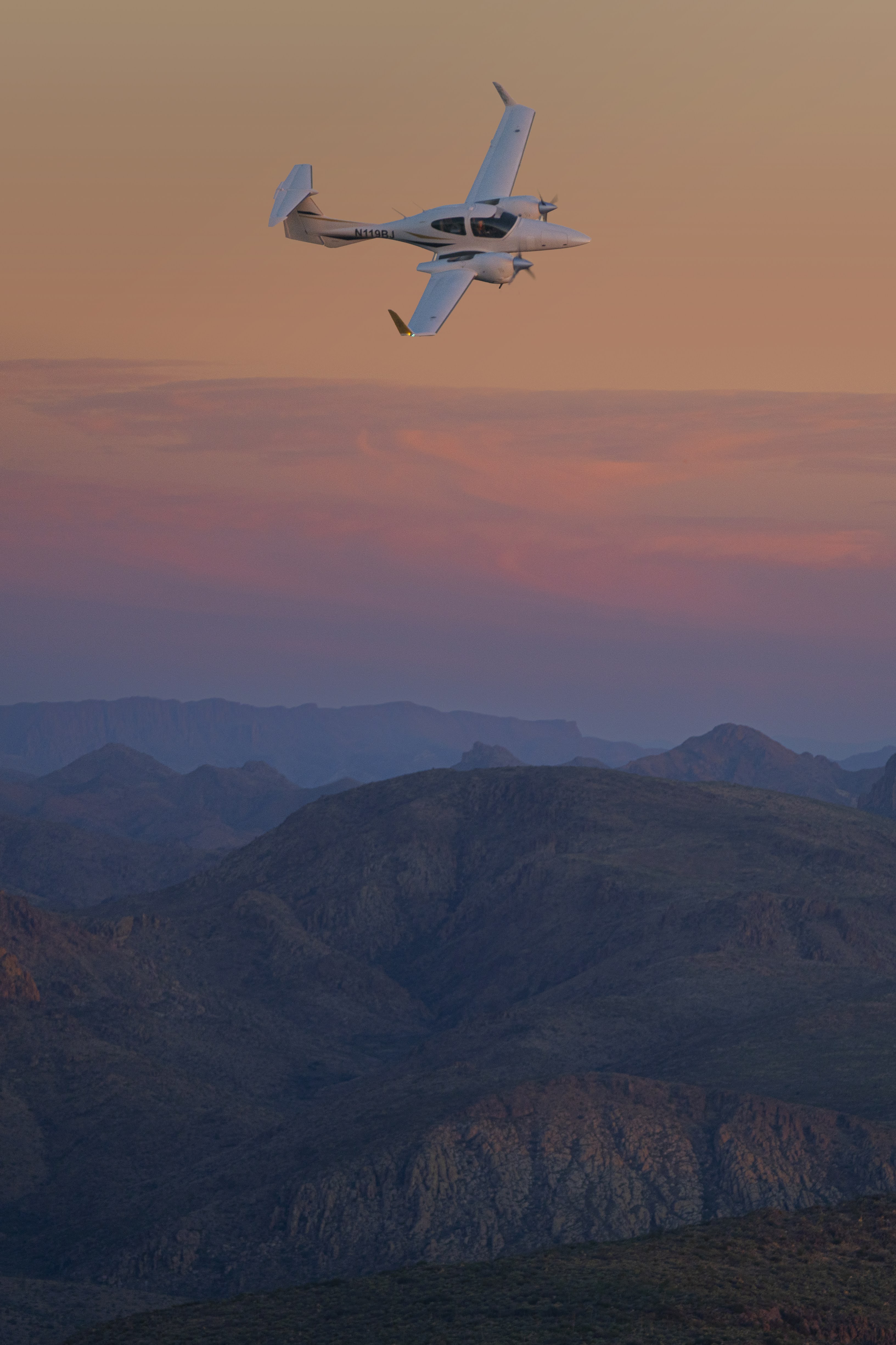 Diamond DA42 in flight at sunset