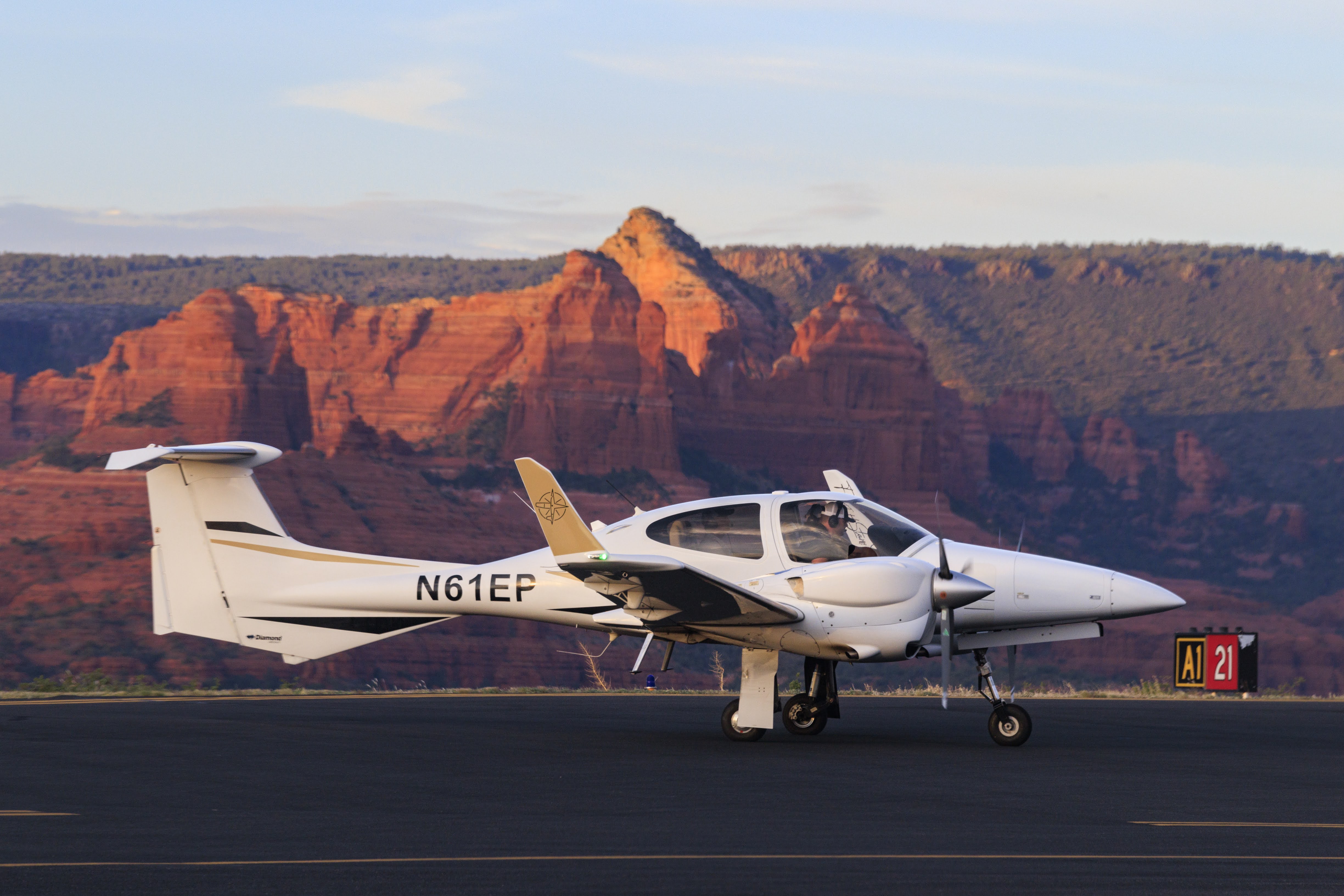 Diamond DA42 on runway with Sedona red rock mountains in the background